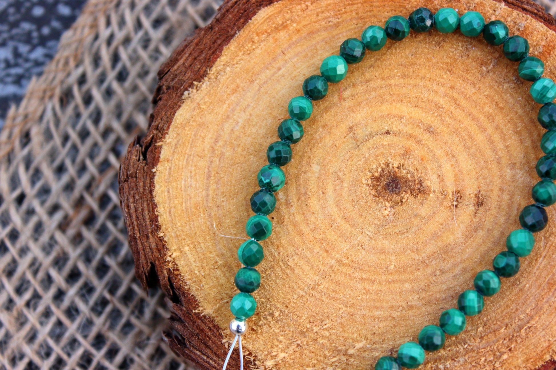 Green beaded bracelet on a wooden surface