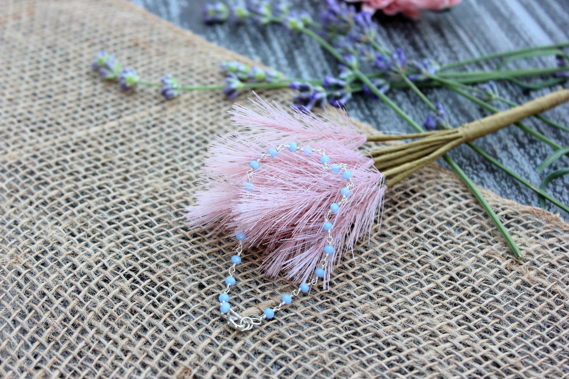 Blue beads on a textured fabric background