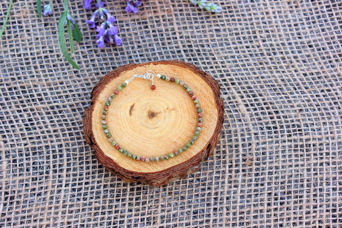 Wooden ring with beads on a textured fabric background