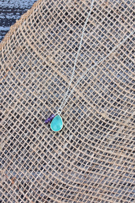 Burlap fabric with a small blue stone on a textured surface