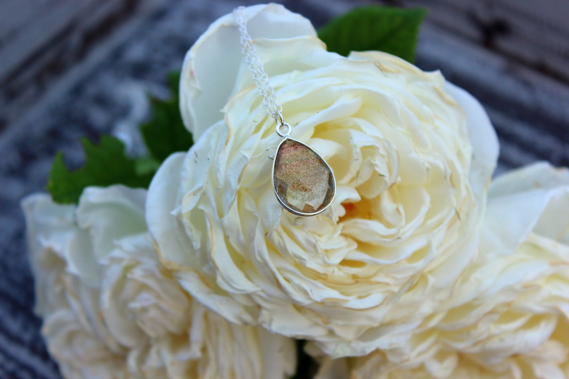 Necklace with a pendant on a bouquet of white roses