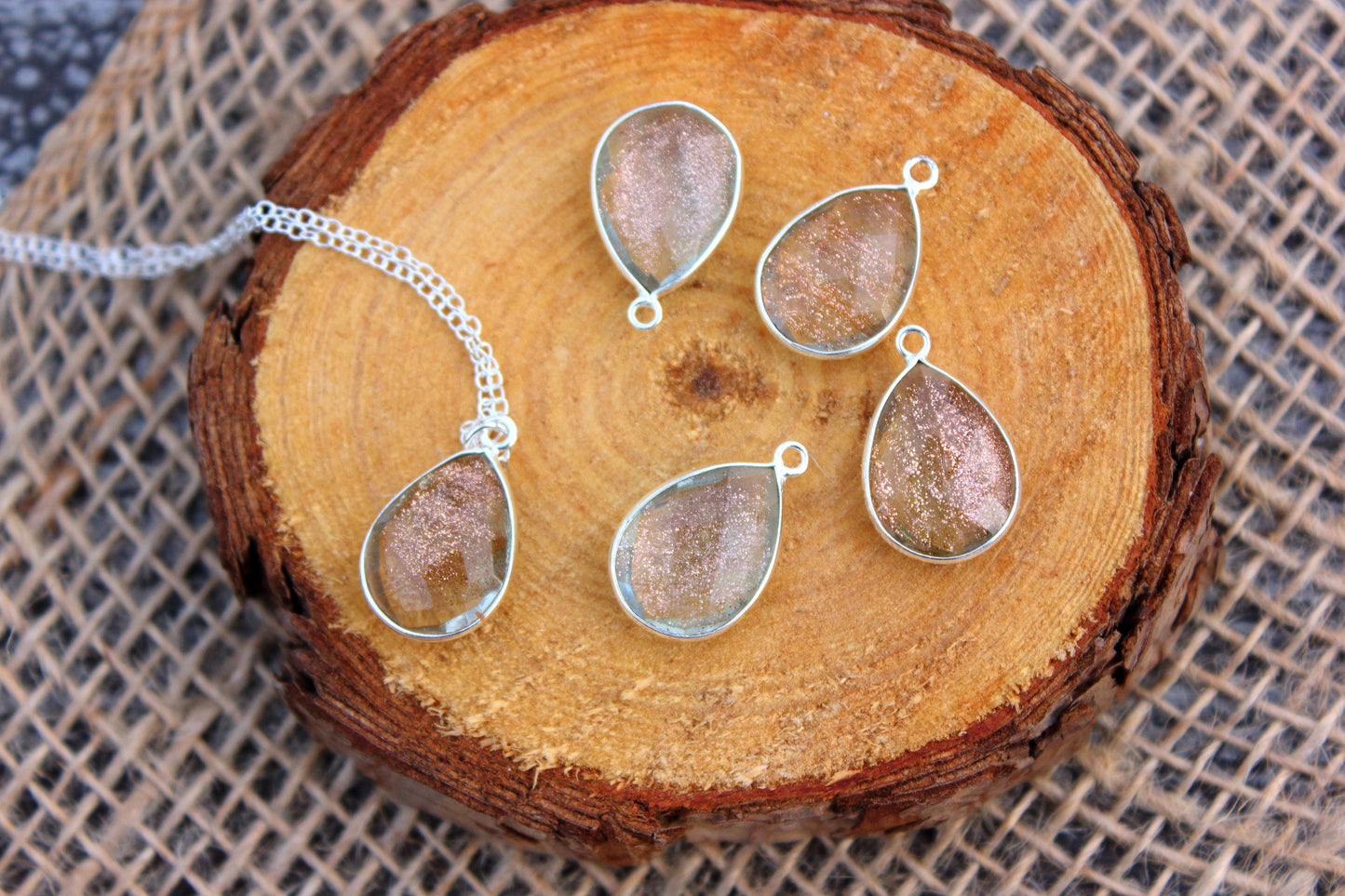 Teardrop-shaped jewelry on a wooden surface