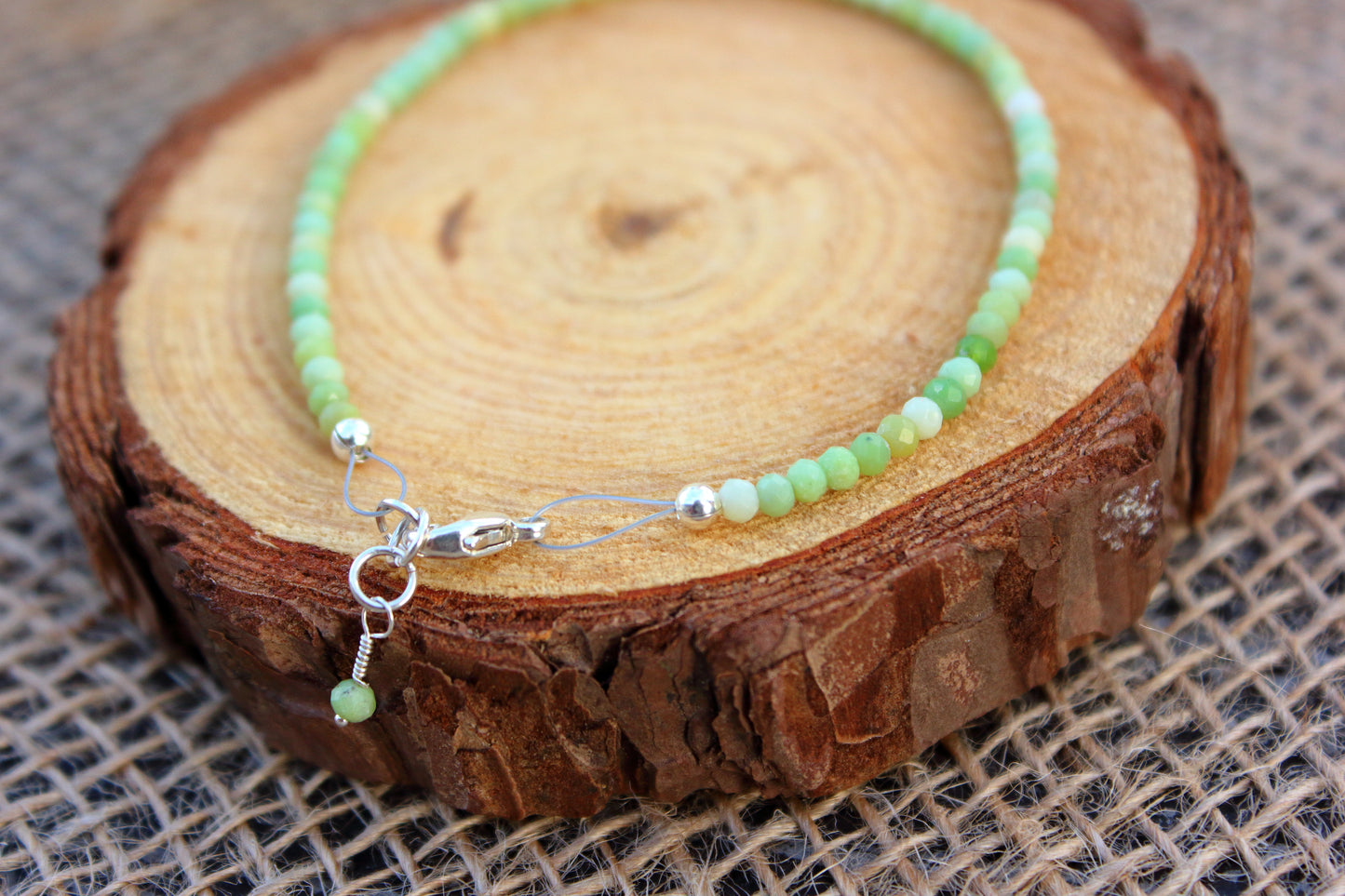 Green beaded bracelet on a wooden surface