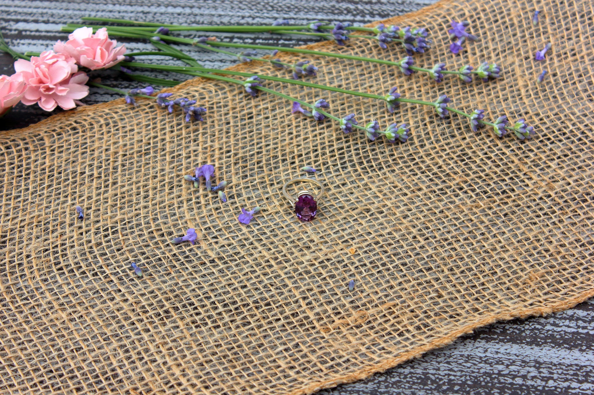 Burlap fabric with scattered flowers on a textured surface